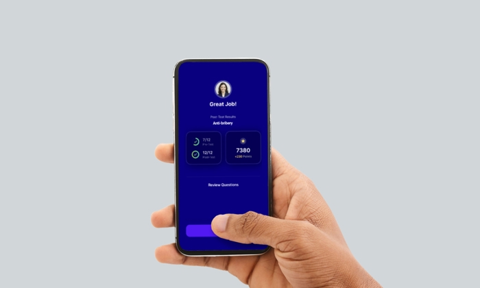 A person holds a smartphone displaying a success screen from an app, showing test results, achieved points, and an option to review questions against a blue background.